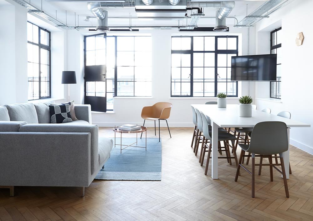 Picture of a green recycling symbol on a white background. Symbol is two pointed arrows arranged in a circle.